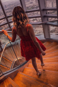 Rear view of woman walking on steps