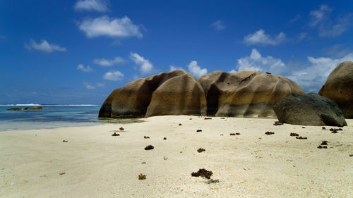 Panoramic view of rocks on beach against sky