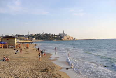 People on beach against sky