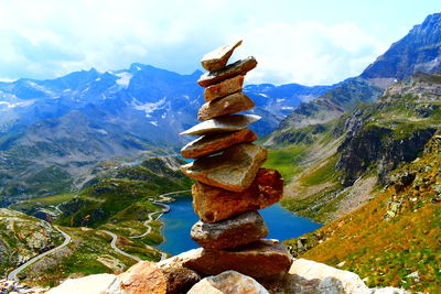 Stack of rocks on mountain against sky