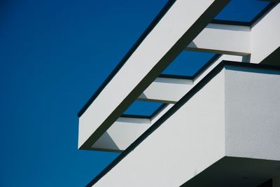 Low angle view of building against clear blue sky