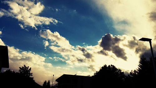 Low angle view of silhouette tree against cloudy sky