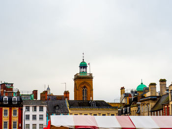 Low angle view of buildings in city against sky