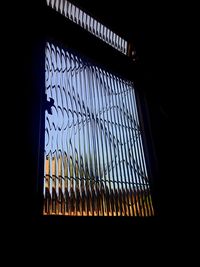 Low angle view of building seen through window