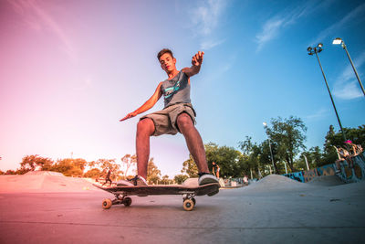 Low angle view of man skateboarding against sky