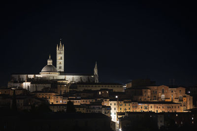 Illuminated buildings in city at night