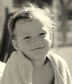 Close-up portrait of smiling boy in beach towel