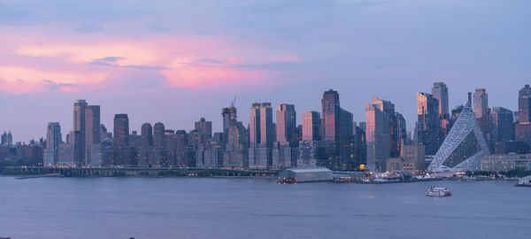 Panoramic view of city buildings against sky during sunset