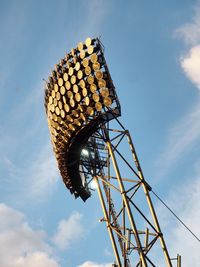 Low angle view of floodlights tower against sky