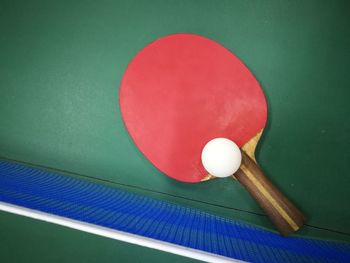 Close-up of racket and ball on tennis table