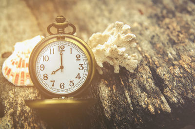 Close-up of antique pocket watch on wooden table