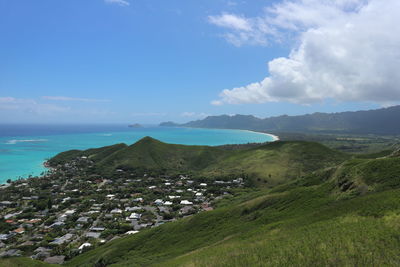 Landscape photo near lanikai, hawaii. blue water, green mountains, small village.