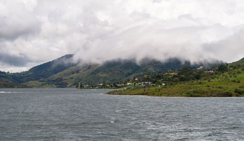 Scenic view of lake and mountains against sky