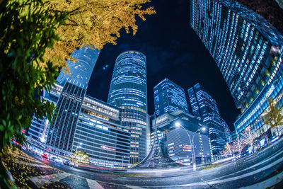 Illuminated modern buildings in city at night