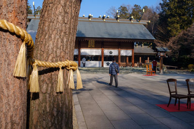 Rear view of woman standing against built structure