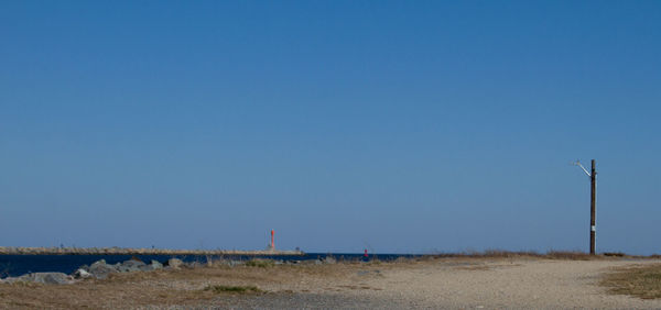 Scenic view of land against clear blue sky