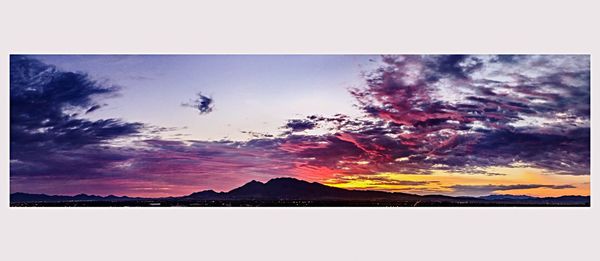 Scenic view of mountains against sky at sunset