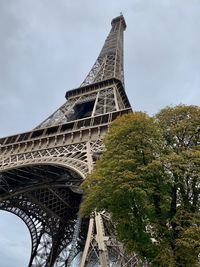 Low angle view of tower against cloudy sky