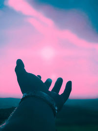 Silhouette person against sky during sunset