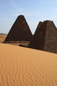 Stone wall in desert against sky