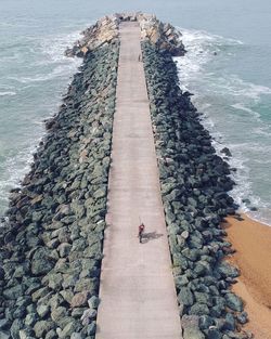 High angle view of people on rock by sea