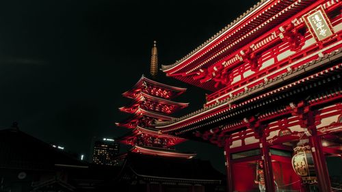 Low angle view of illuminated building against sky at night
