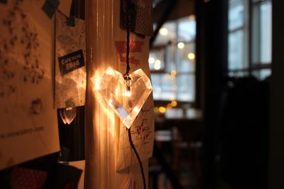 Close-up of illuminated lighting equipment hanging at home