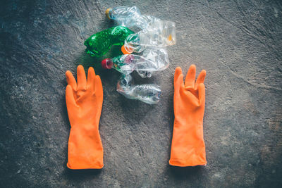 High angle view of hand holding orange on table