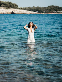 Full length of man standing in sea