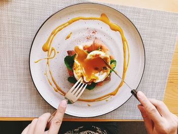 Midsection of person holding ice cream in plate