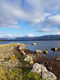 Scenic view of sea and mountains against sky