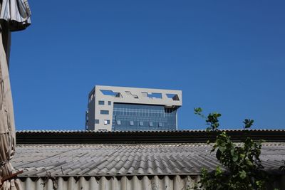 Low angle view of building against clear blue sky