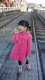 Beautiful little girl standing on the trails 