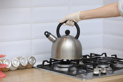 Cropped hand preparing food in kitchen