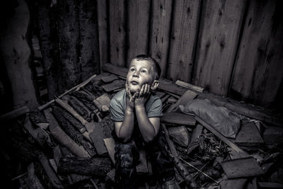 High angle view of frightened boy looking up in abandoned room
