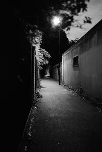 Empty street amidst buildings at night