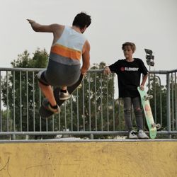 Full length of young man jumping against sky