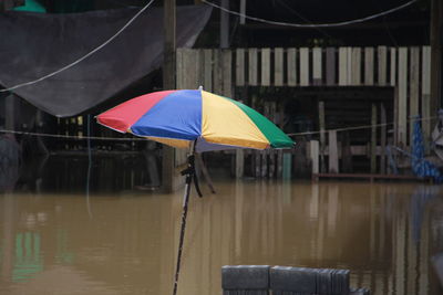 Umbrella on wet table during rainy season