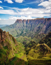 Scenic view of mountains against cloudy sky