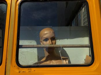 Mannequin seen through vehicle window