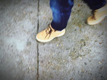 Low section of woman standing on tiled floor