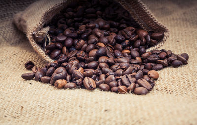 Close-up of roasted coffee beans on sack