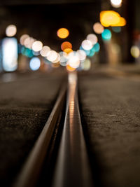 Close-up of illuminated railroad tracks at night