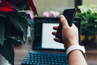 Midsection of man using mobile phone