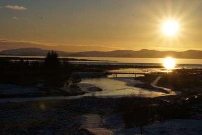 Scenic view of lake against sky during sunset