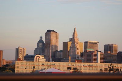 Building in city against sky during sunset