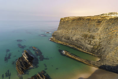 High angle view of rocks by sea against sky