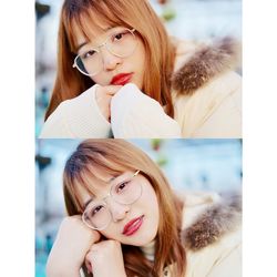 Close-up portrait of a smiling young woman with mobile phone