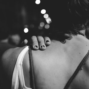 Close-up of woman hand on illuminated lighting equipment