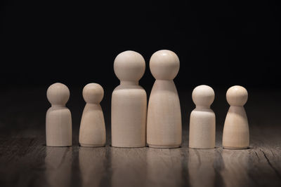 Close-up of coins on table against black background